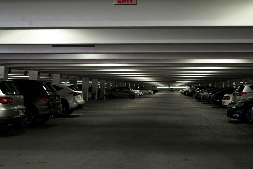 Wide view of a multi-storey parking garage with parked cars in Los Angeles, CA.