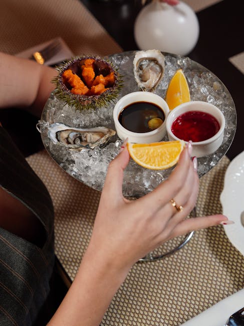 Close-up of a gourmet seafood platter featuring fresh oysters, sea urchin, and sauces, perfect for fine dining.